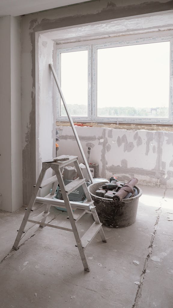 Sunlit room under renovation with tools and ladder, embodying modern DIY projects